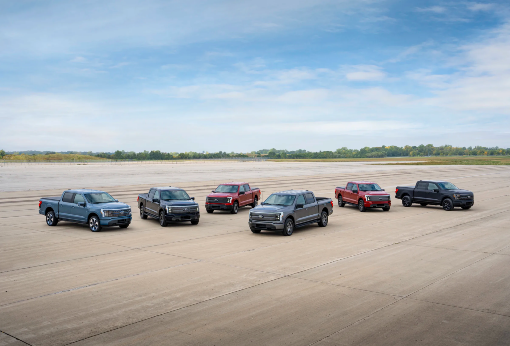 Six Ford F-150 Lightning electric pickups parked on an airfield