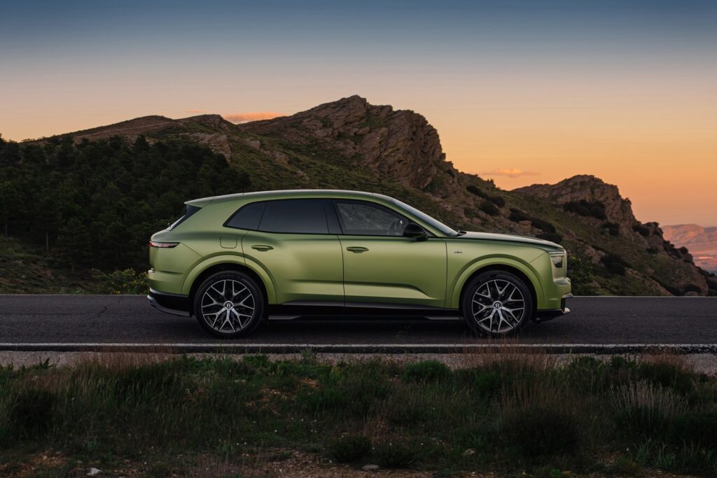 Side profile of the Bentley Torcal on a mountain road at sunset