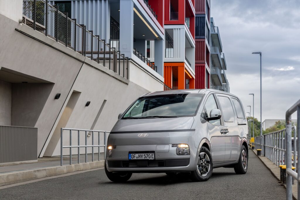 Silver Hyundai STARIA Cargo electric van in a front three-quarter view on a city street
