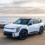White 2026 Kia EV9 on a beach, a Kia America media photo.