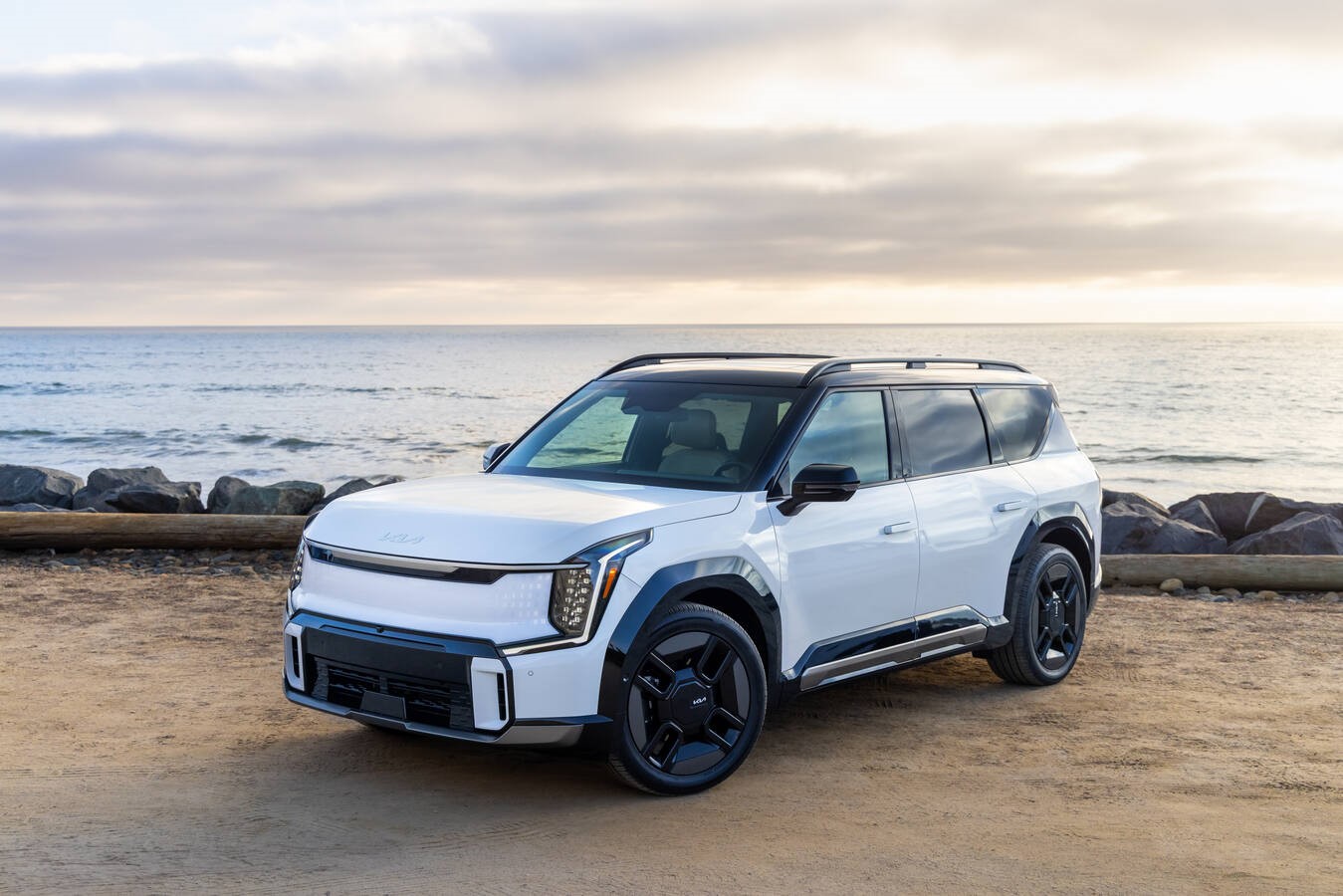 White 2026 Kia EV9 on a beach, a Kia America media photo.