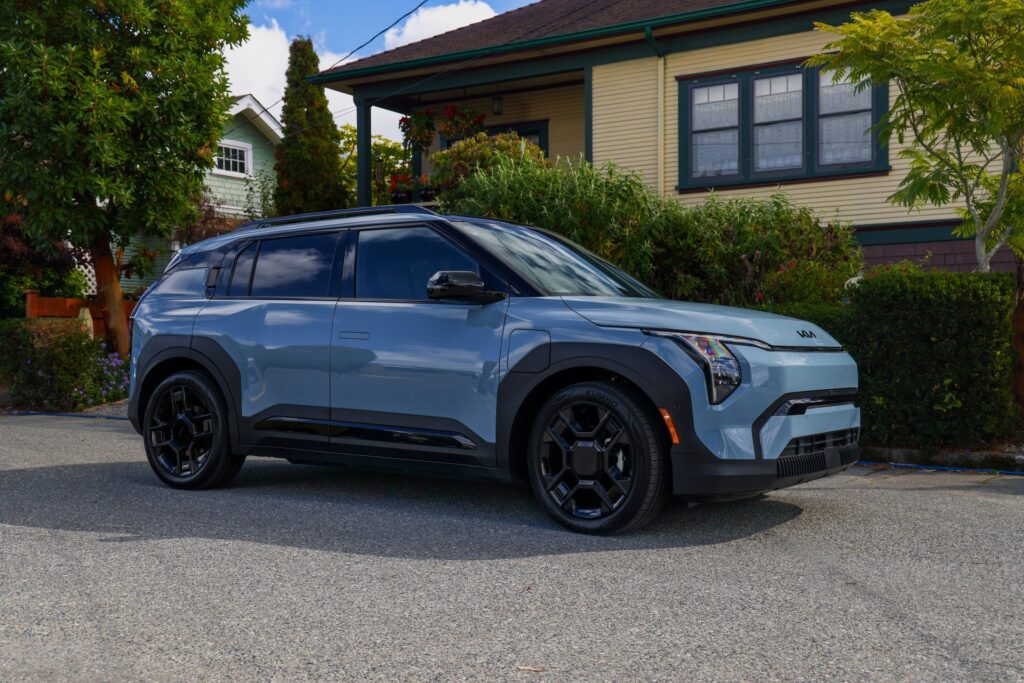 Light blue 2027 Kia EV3 with black wheels, front three-quarter view