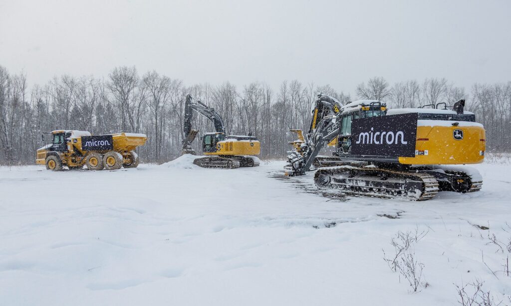A Micron-branded excavator and other heavy equipment on the snowy Clay, New York site in January 2026