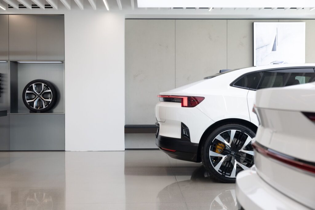 Interior of a U.S. Polestar Space retail location with cars on the floor