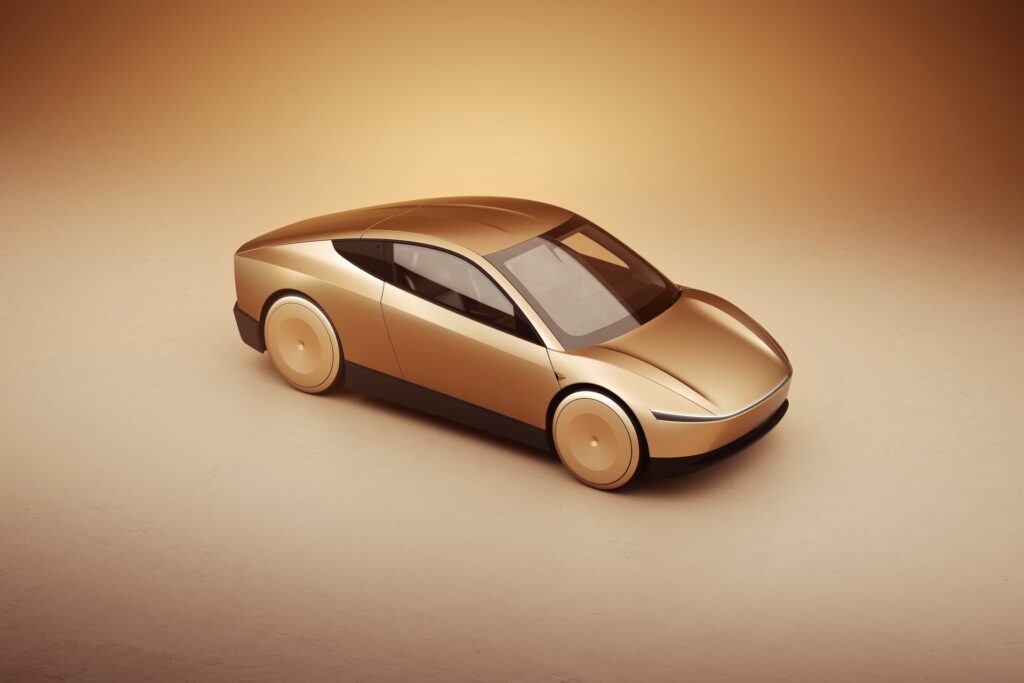 Gold Tesla Cybercab from a high front angle showing the glass roof and tapered body in a studio
