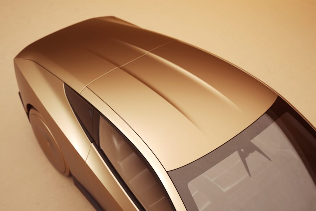 Overhead close-up of the gold Tesla Cybercab roof tapering toward the rear