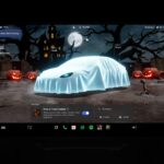 Tesla center display showing Halloween Mode ghost costume avatar in a graveyard Park scene from update 2026.38.3