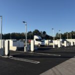 Tesla Megacharger posts at the new Conley, Georgia site with a Tesla Semi in the background