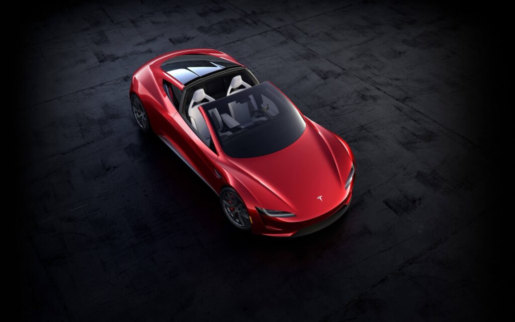 Overhead view of the red second-generation Tesla Roadster prototype with its glass roof removed and four white seats
