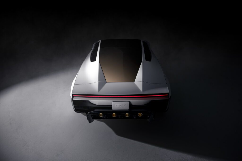 Overhead rear view of a white Tesla Roadster with its light bar, RDSTR plate and four thruster nozzles
