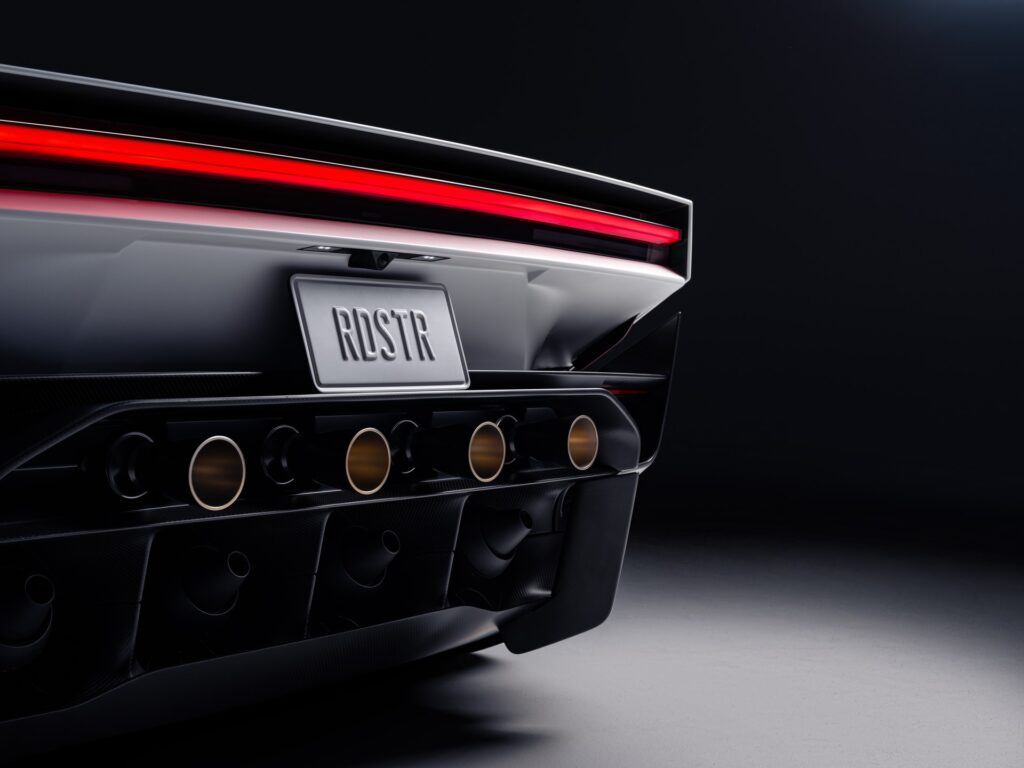 Rear of the new Tesla Roadster showing a full width light bar, an RDSTR plate and a row of thruster nozzles