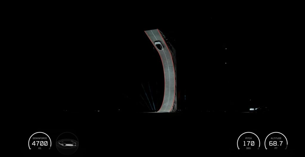 Tesla Roadster driving up a fully vertical ramp that curves past upside down during the reveal