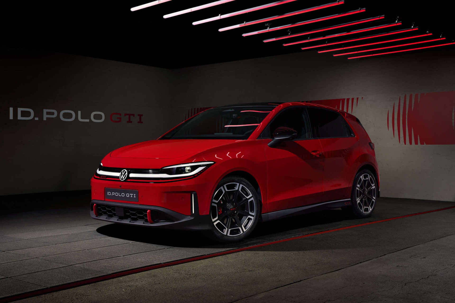 Red Volkswagen ID. Polo GTI front three-quarter view in a studio, the first all-electric GTI