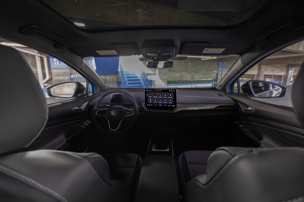 Interior of a 2025 Volkswagen ID.4 showing the steering wheel and center touchscreen